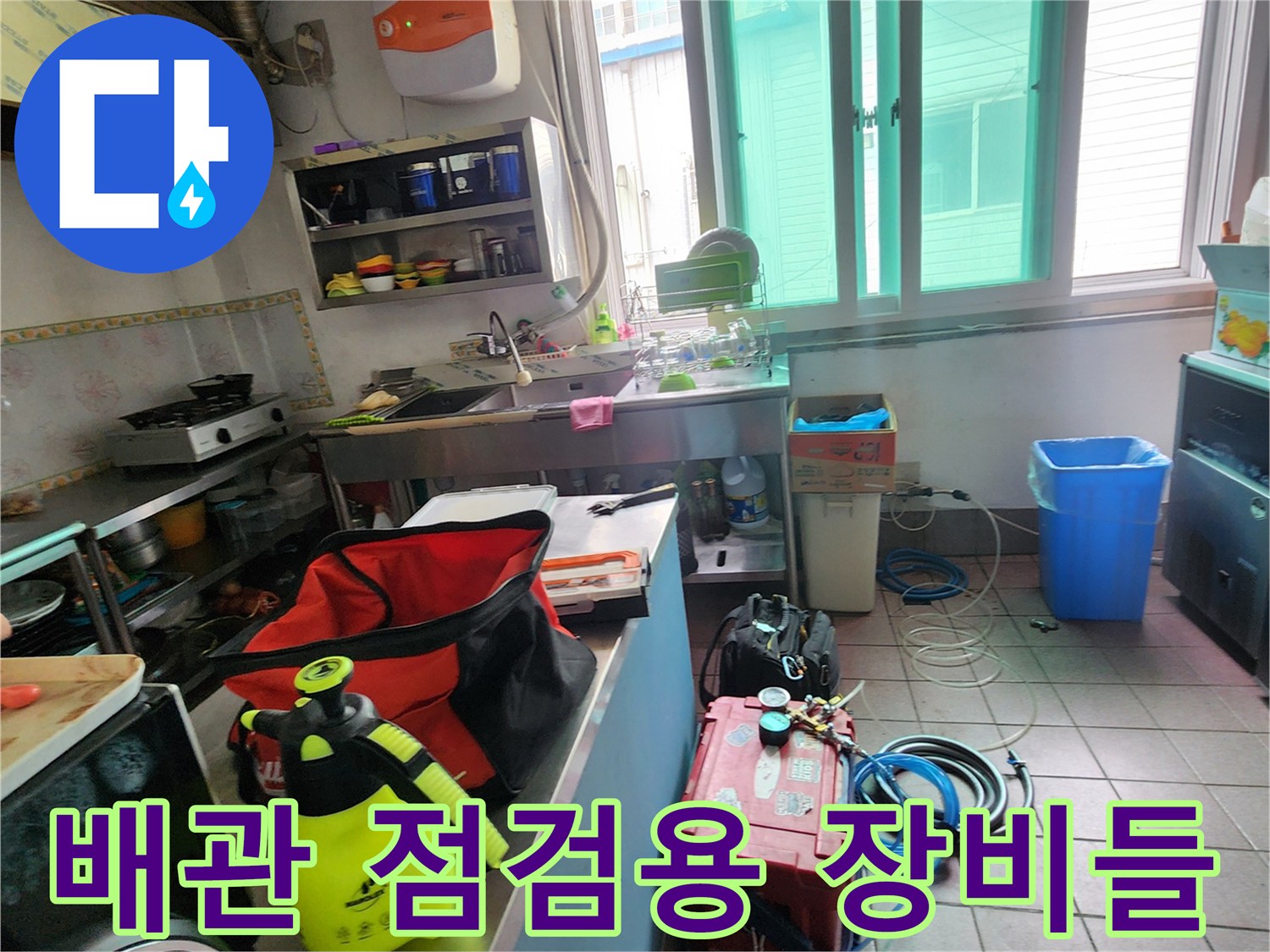 주방 바닥에 배치된 누수 탐지용 압력계와 가스 주입용 호스
