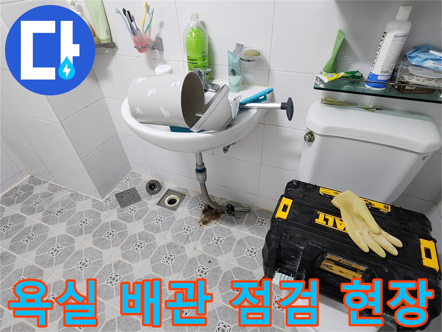 포천시 군내면 화장실 배수구 주변의 노출된 배관과 작업 도구들