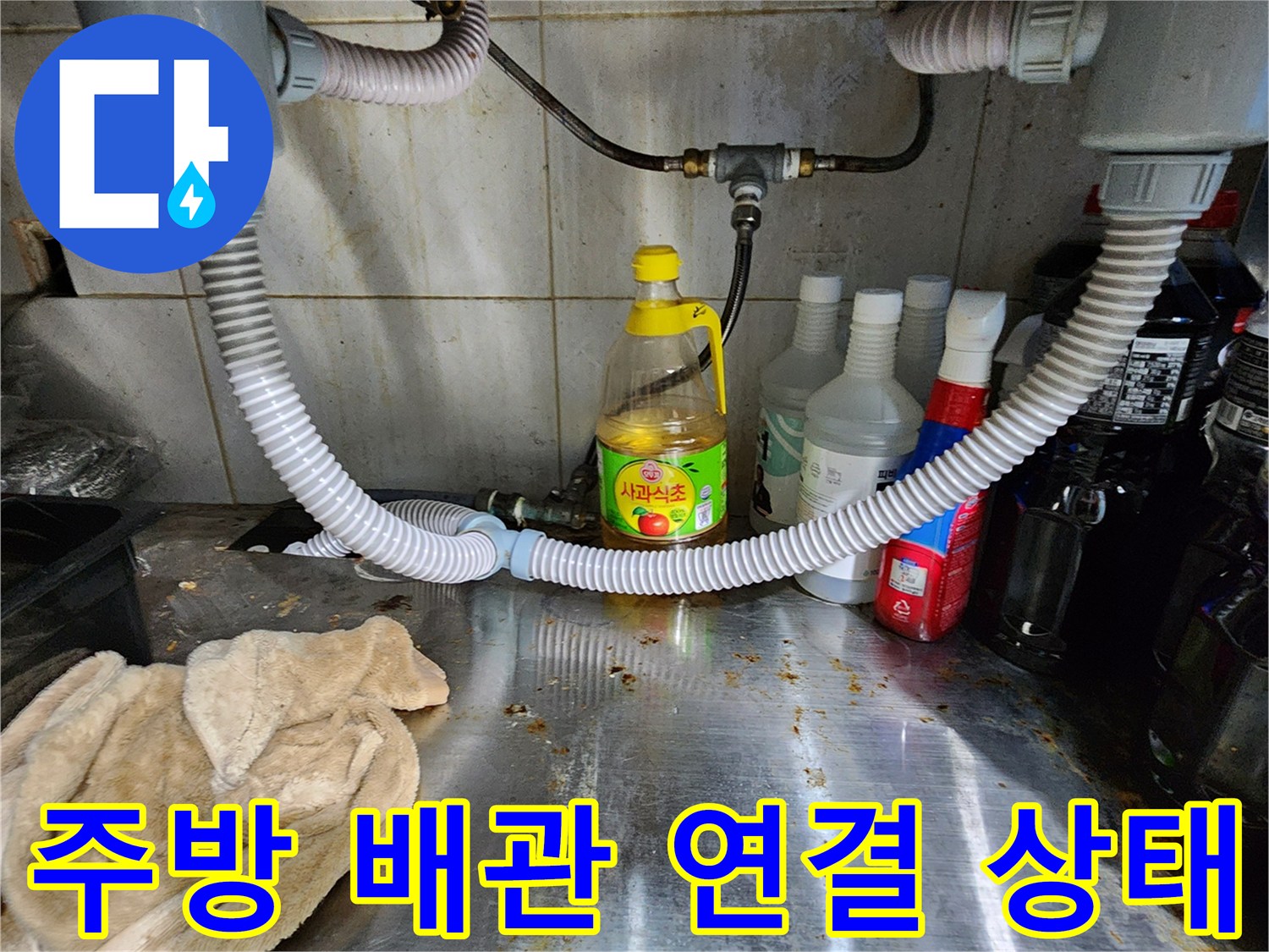 싱크대 하단 배수 호스의 굴곡과 벽면 배관의 접합부 사진입니다.