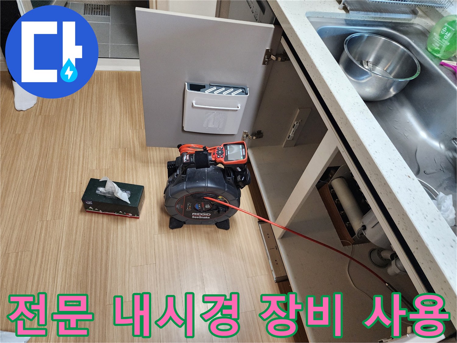 Ridgid 브랜드의 전문 배관 내시경 장비를 싱크대 하부에 배치한 모습입니다.