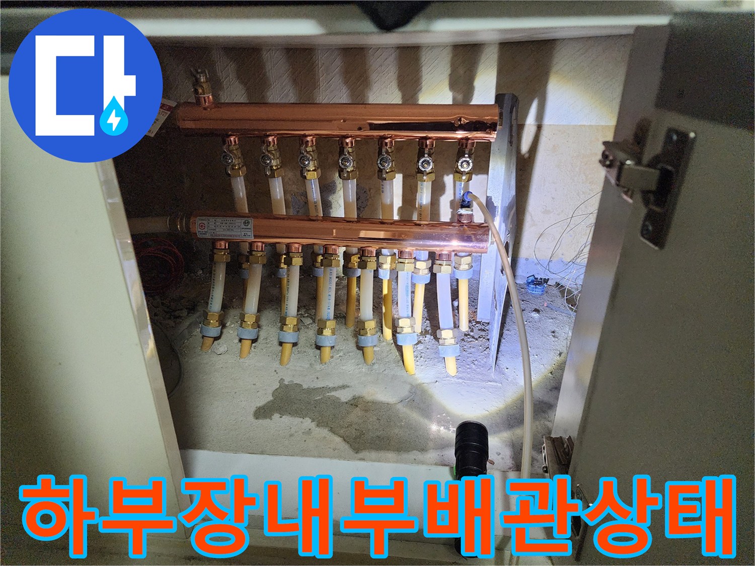 싱크대 하부장에 노출된 구리 분배기와 보온재 마감 배관