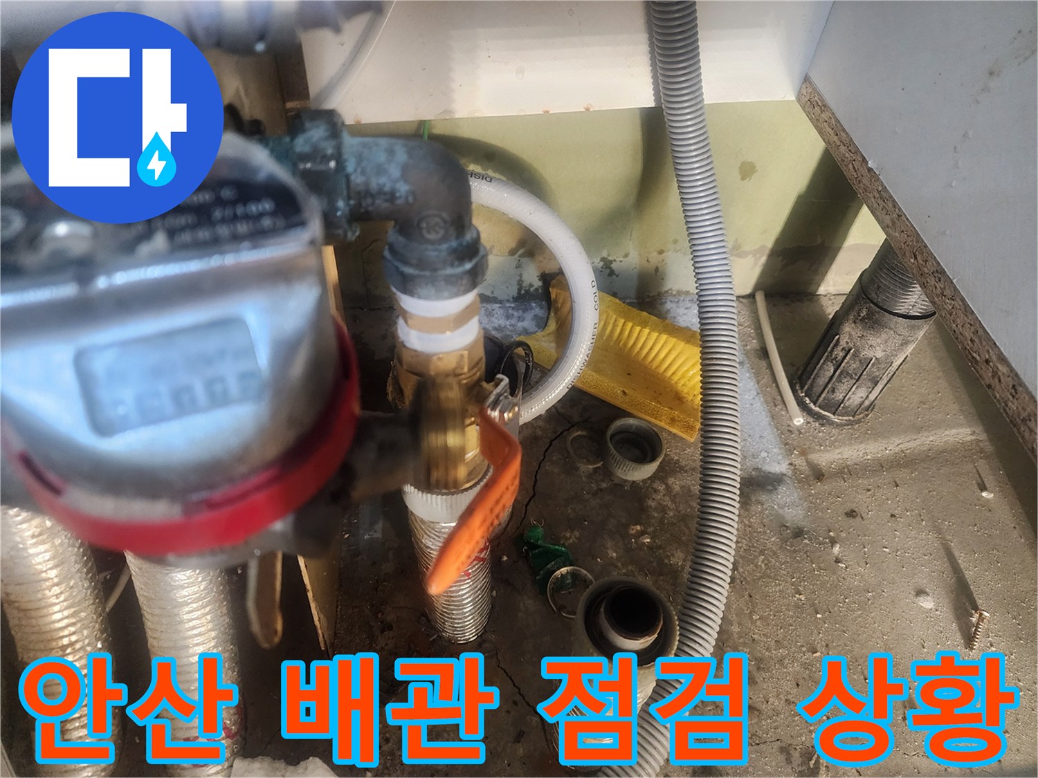안산 고잔동 아파트-싱크대 하부장 내부의 노후된 배관과 밸브 상태를 확인하는 모습입니다.