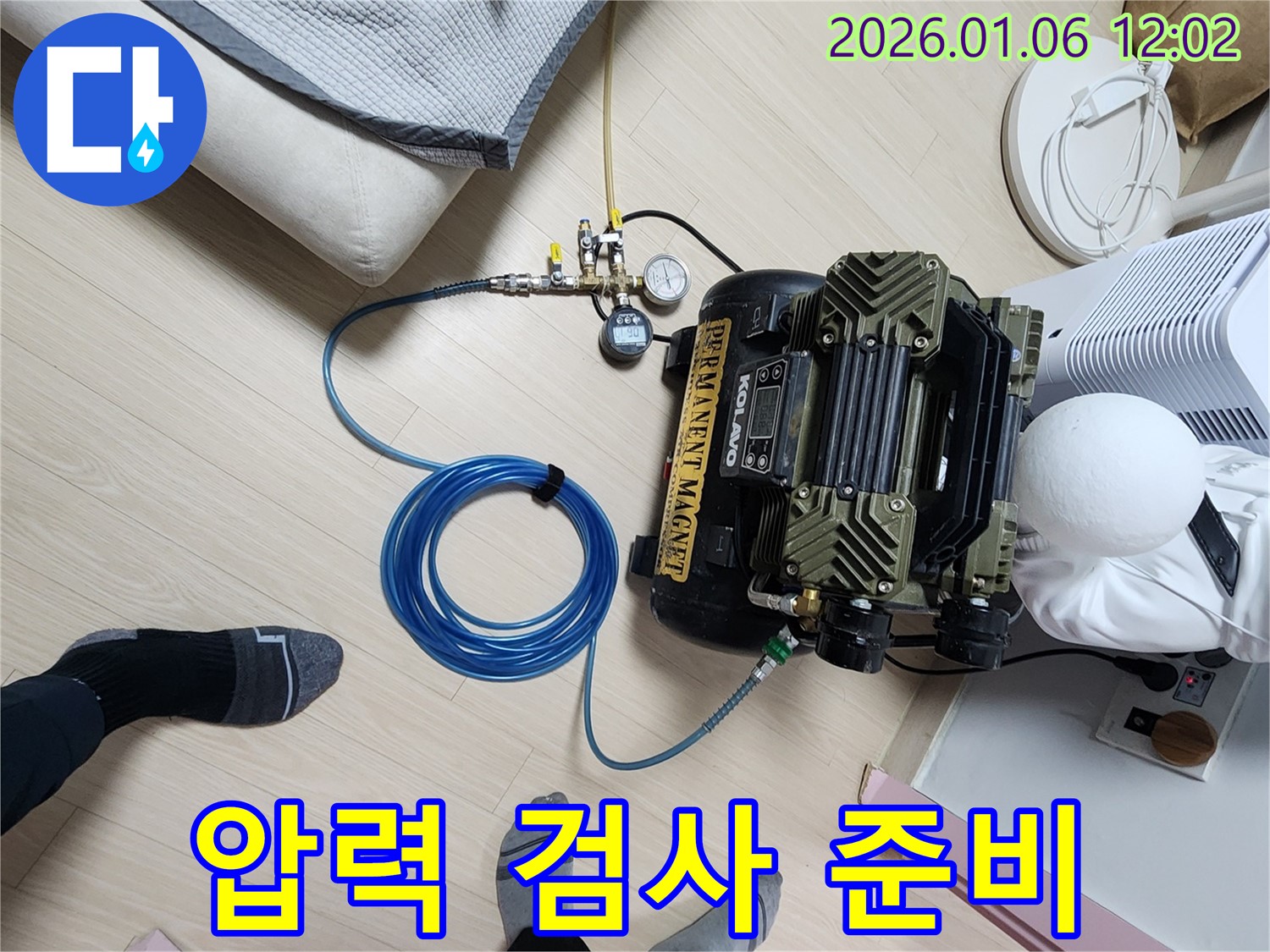 누수 탐지를 위한 압력 검사 준비 과정 - 콤프레샤와 연결된 호스를 통해 배관 내 압력을 조절하여 누수 지점을 찾습니다.