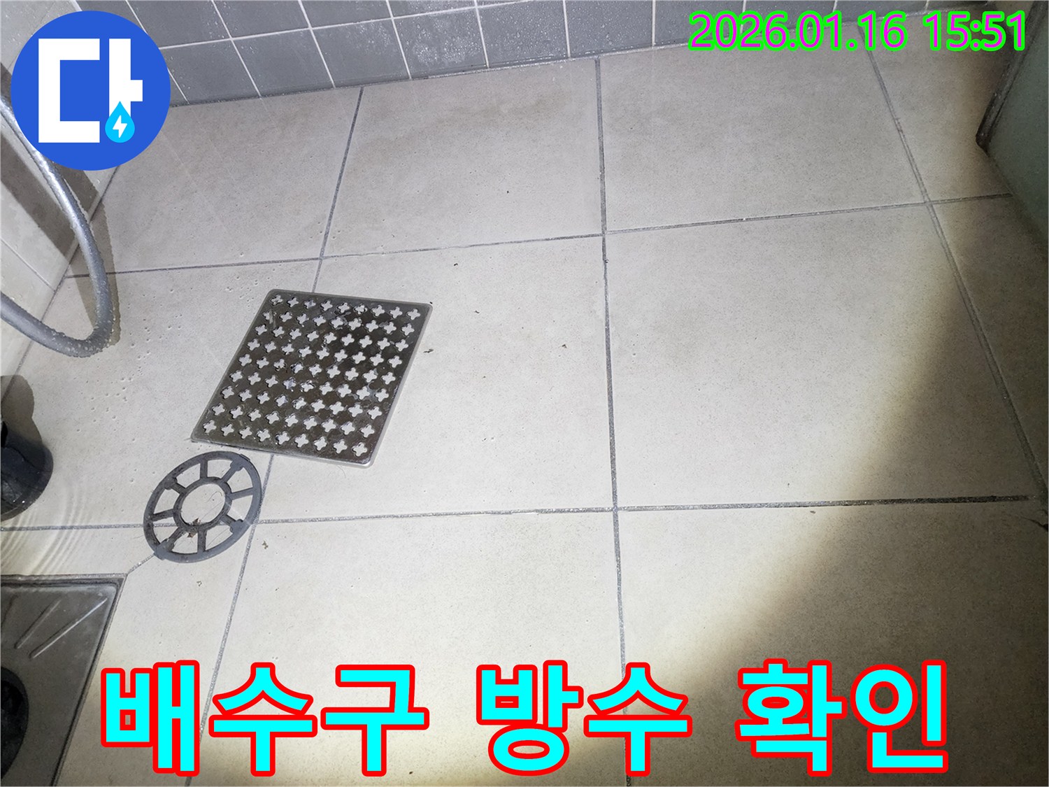 이 이미지는-누수 진단을 위해-욕실 배수구의-덮개를 열고-내부를 점검하는-과정을 담고 있습니다