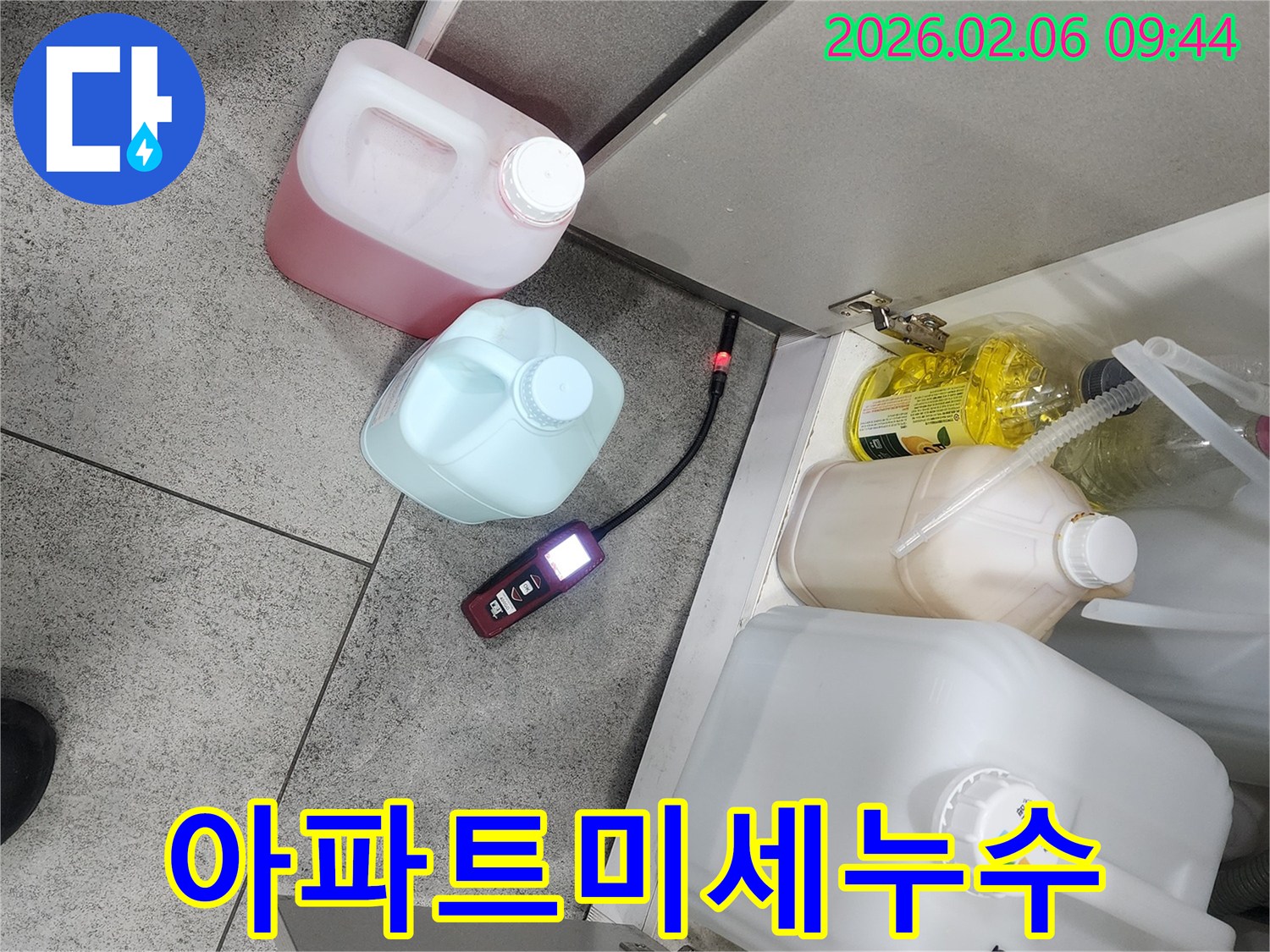 난계로 아파트 주방에서 누수탐지 장비가 미세한 누수 지점을 탐지하고 그 결과를 보고하고 있습니다