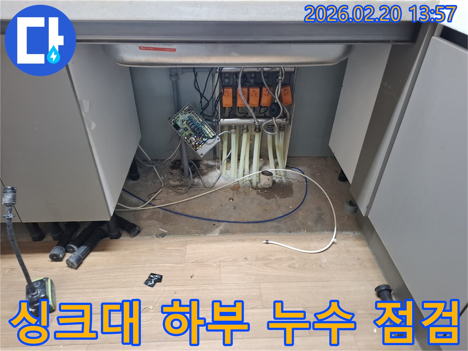 싱크대-아래-복잡하게-얽힌-배관과-전선-사이에서-발생한-누수를-정밀하게-진단하는-모습입니다