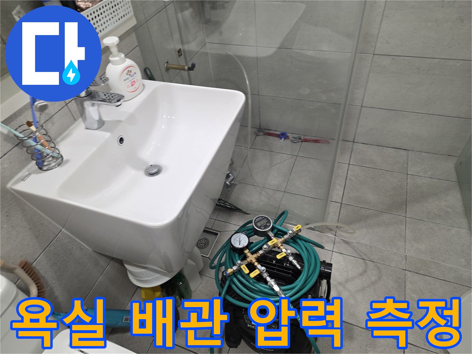 세면대 아래쪽-설치된 누수 진단용 공압 장비 모습