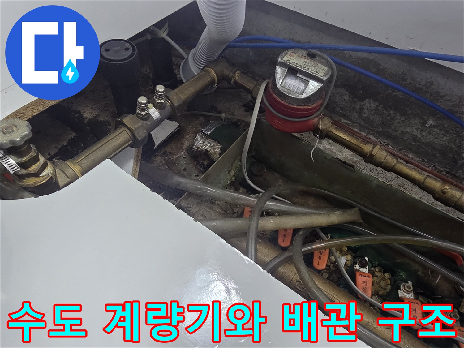 싱크대 하부의 수도 계량기와 연결된 급수 배관들