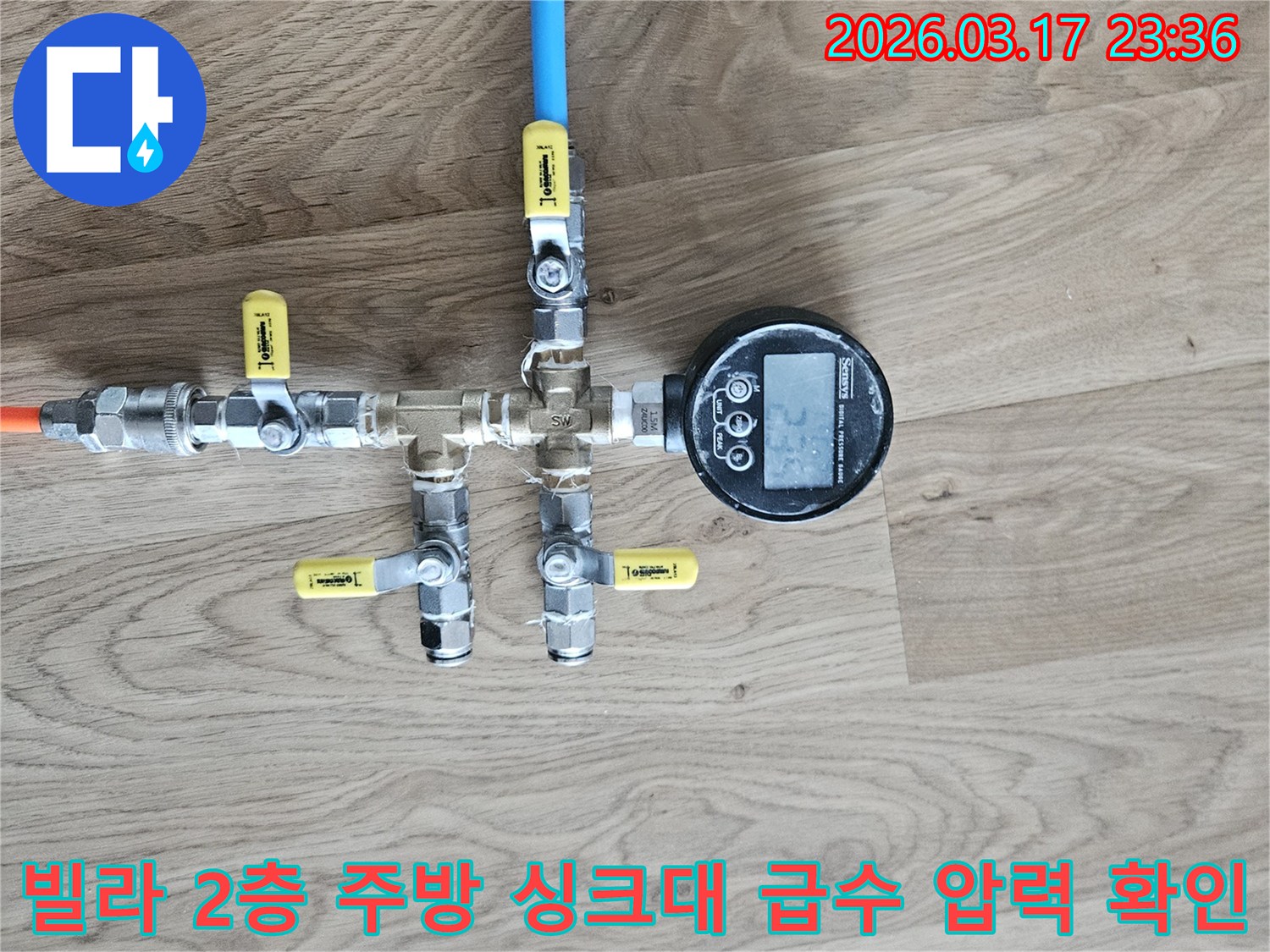 빌라 2층 주방 싱크대 급수 배관의 누수 발생 여부를 확인하기 위해-배관에 연결된 압력계를 통해-정확한 수치를 측정하고 있습니다.