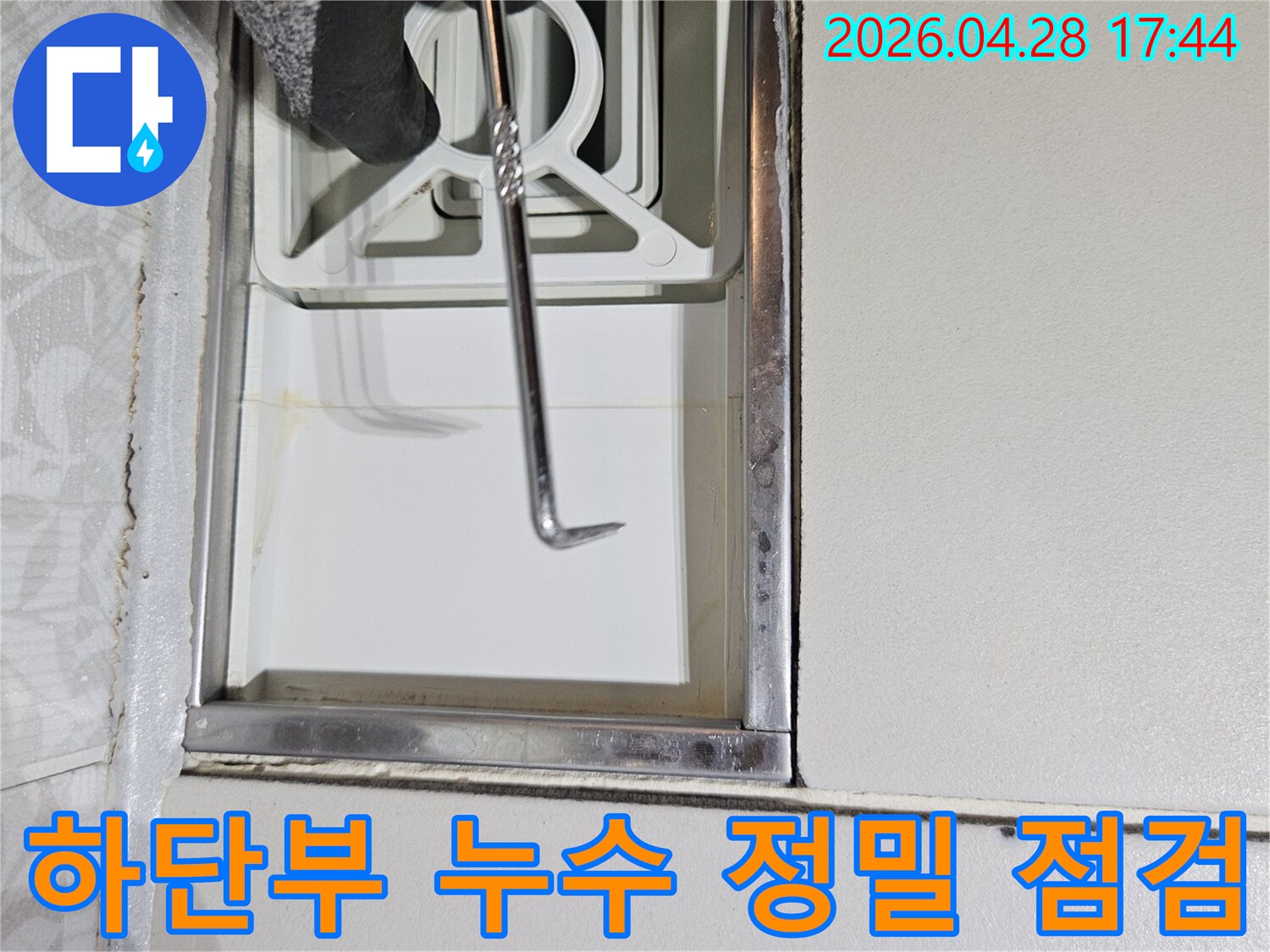 누수 전문가가-특수 도구를 사용하여-주택 벽면 하단부의-누수 여부를-정밀하게-점검하는 사진입니다