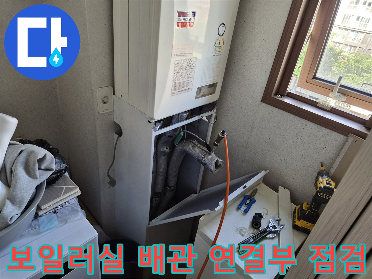 보일러 하단에 노출된 회색 배관과 부속들의 결합 상태 촬영