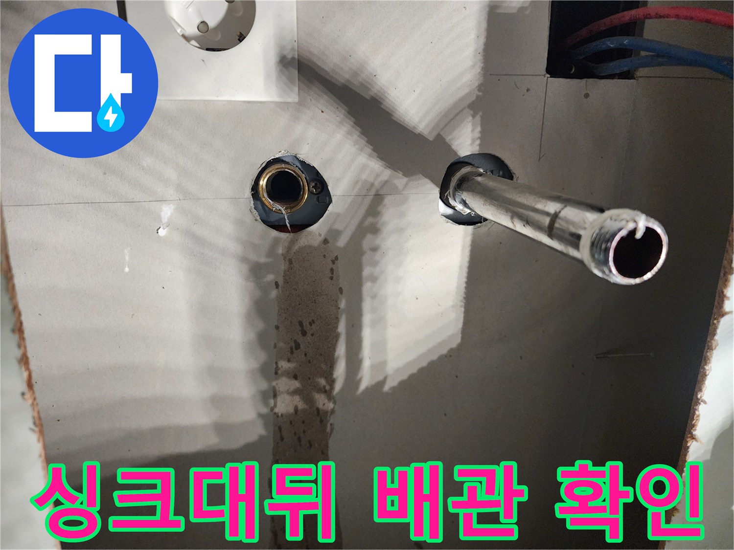 용인 수지구 싱크대 뒤편 벽체 내부에 노출된 온수 배관과 파란색 급수관의 상태
