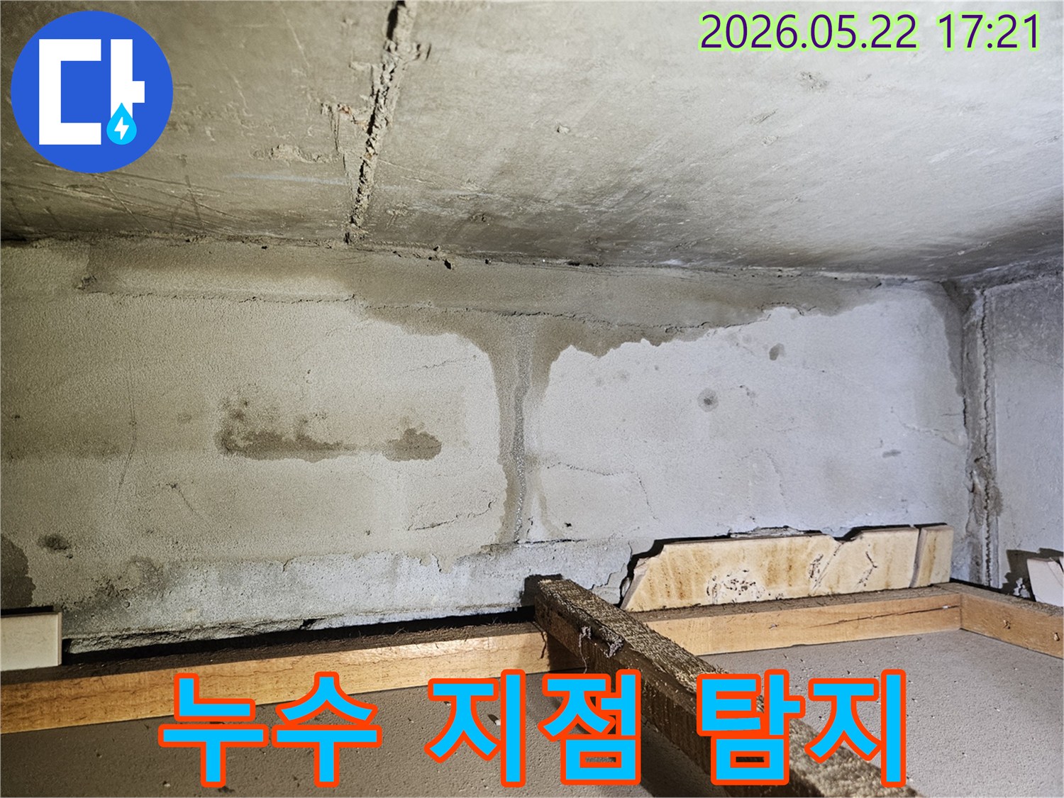 천장과 벽면의 연결 부위에서 물이 흘러내려-심한 물자국과 얼룩을 남긴-누수 발생 현장의 클로즈업 이미지