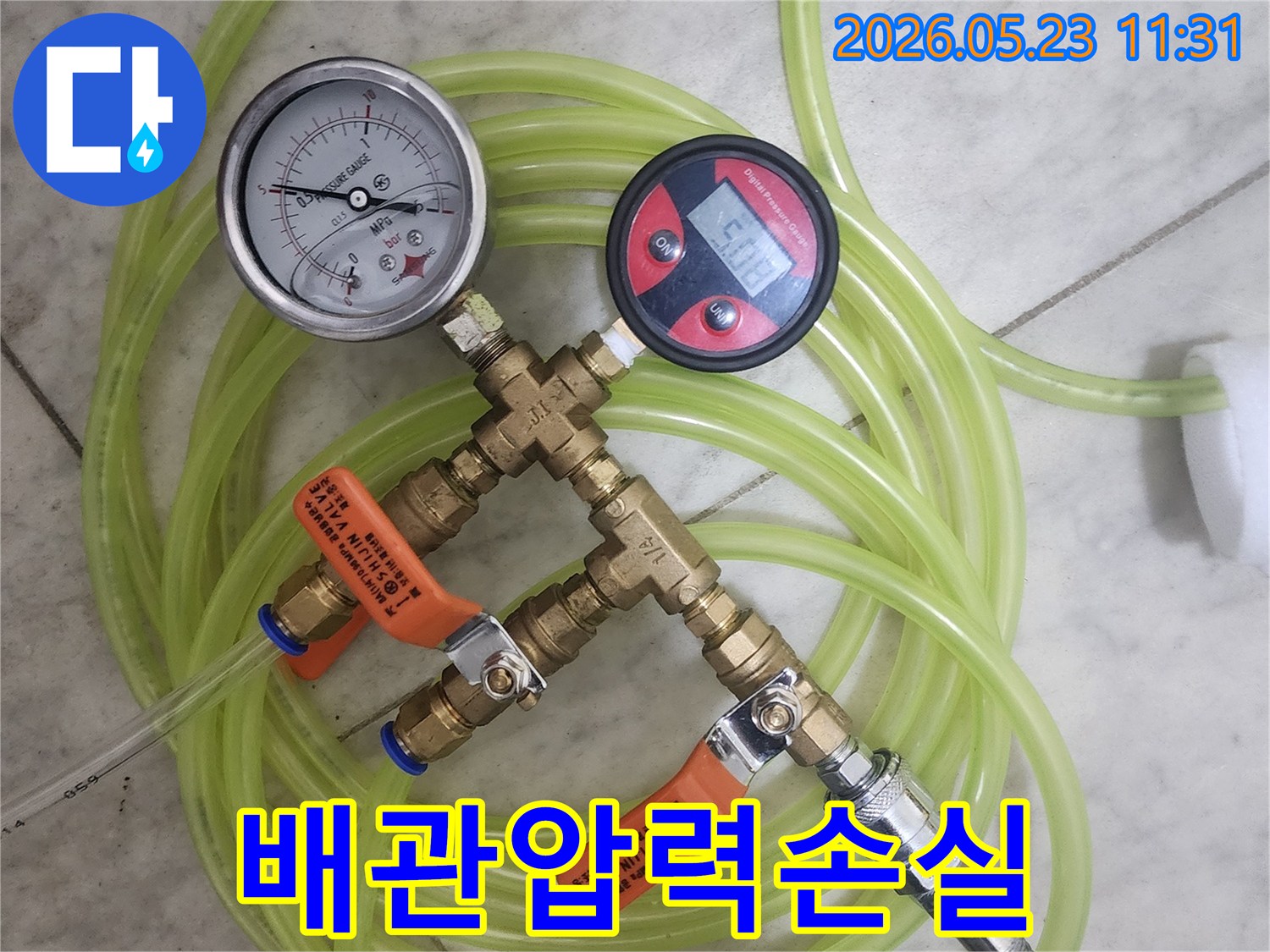 주택-누수-진단을-위해-배관에-연결된-공압-측정-장비와-호스-모습