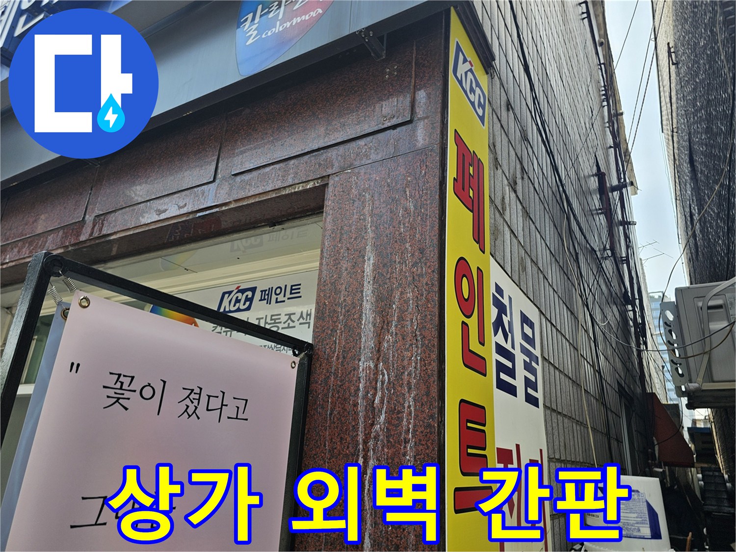 용인 수지구 상가 건물 입구의 페인트 간판과 외벽 모습