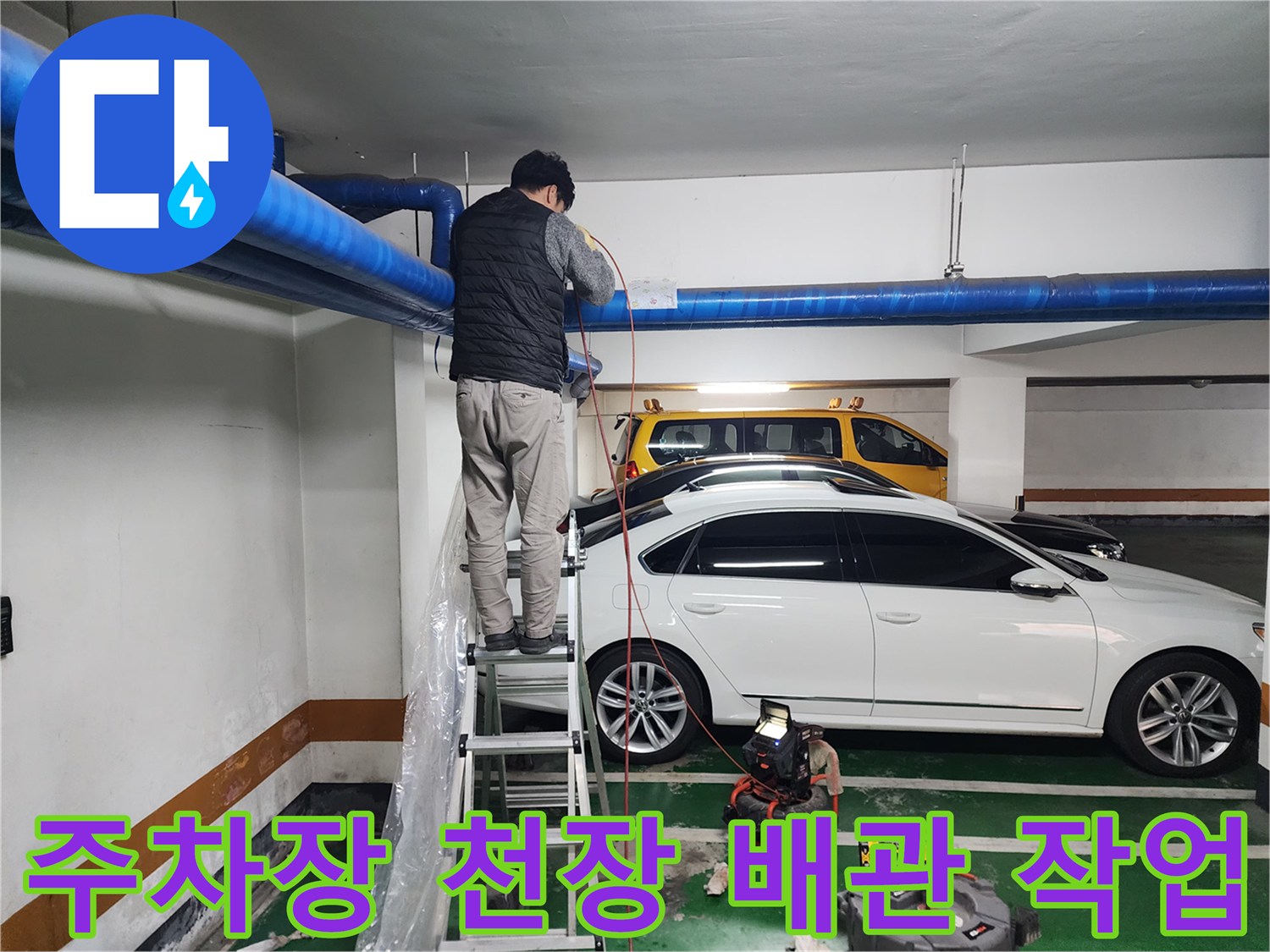 상가 지하주차장 천장 배관을 점검하는 엔지니어의 모습