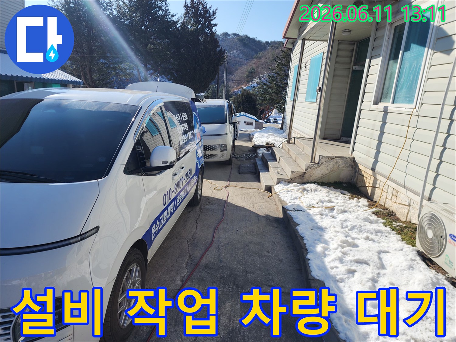 작업용 차량이 주택가 골목에 주차되어 배관 작업을 준비하고 있습니다.