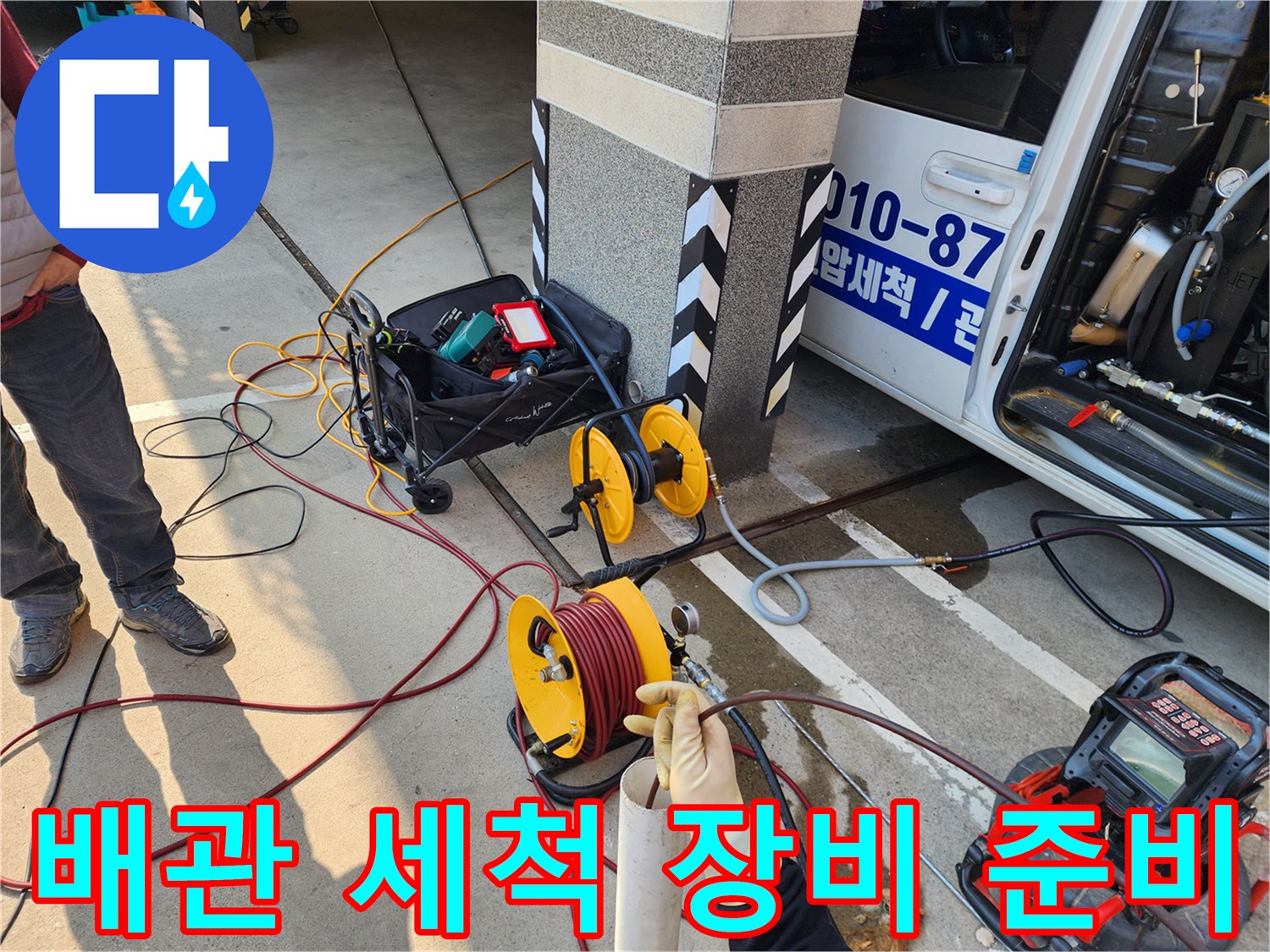 노란색 호스 릴과 배관 내시경 모니터가 배치된 작업 현장