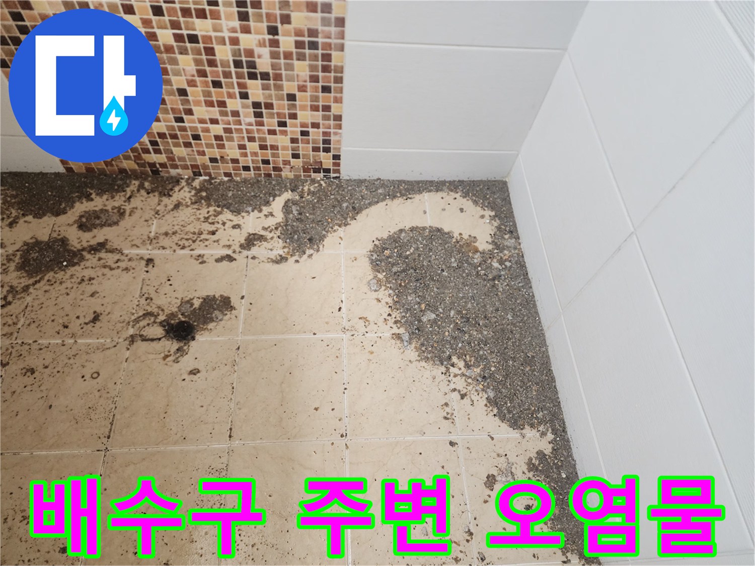 배수구 주변 타일에 흩어진 슬러지와 배수구 입구의 이물질 상태