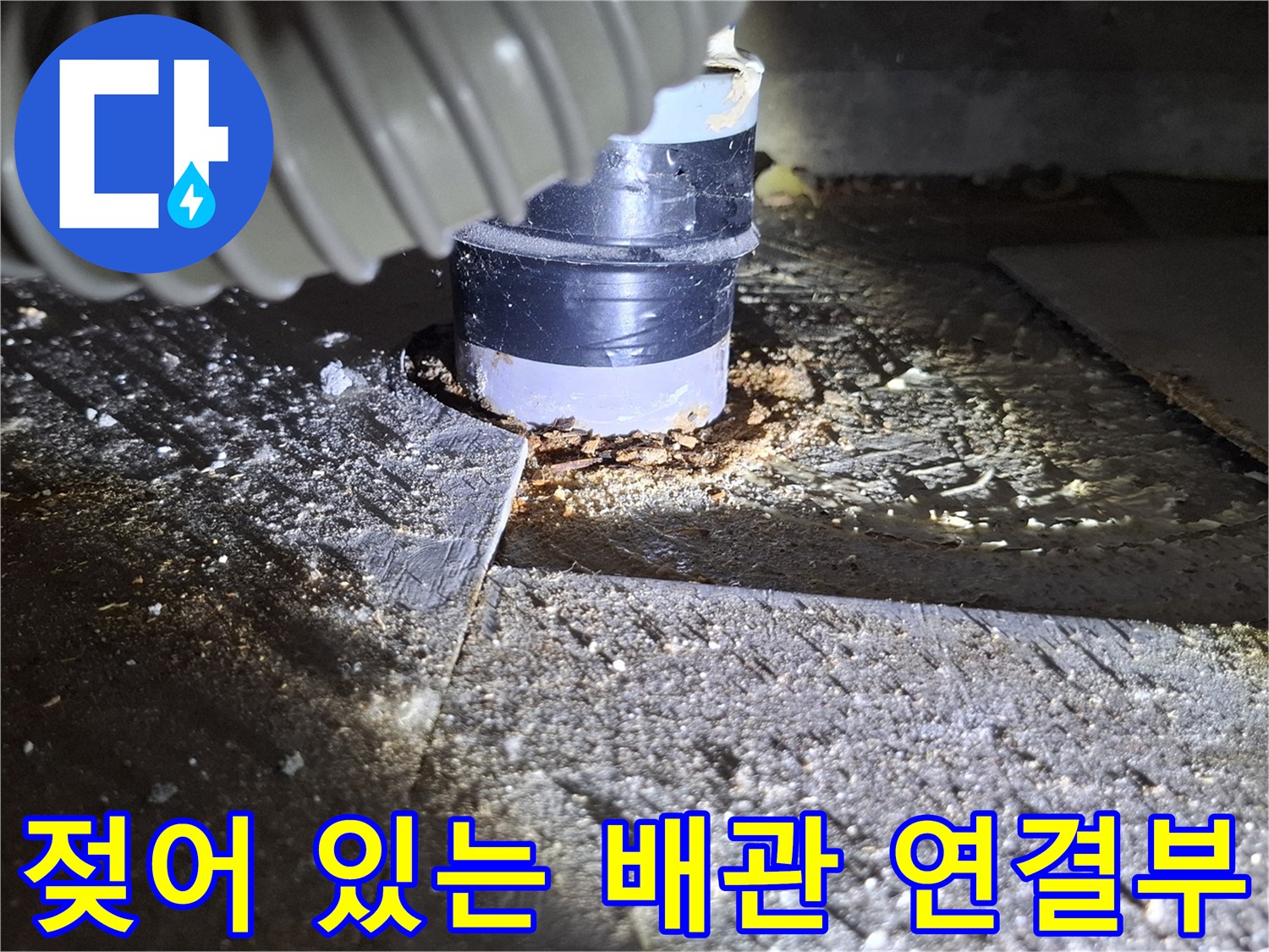 배관 연결 부위와 주변의 젖은 마감재 상태를 촬영한 사진입니다.