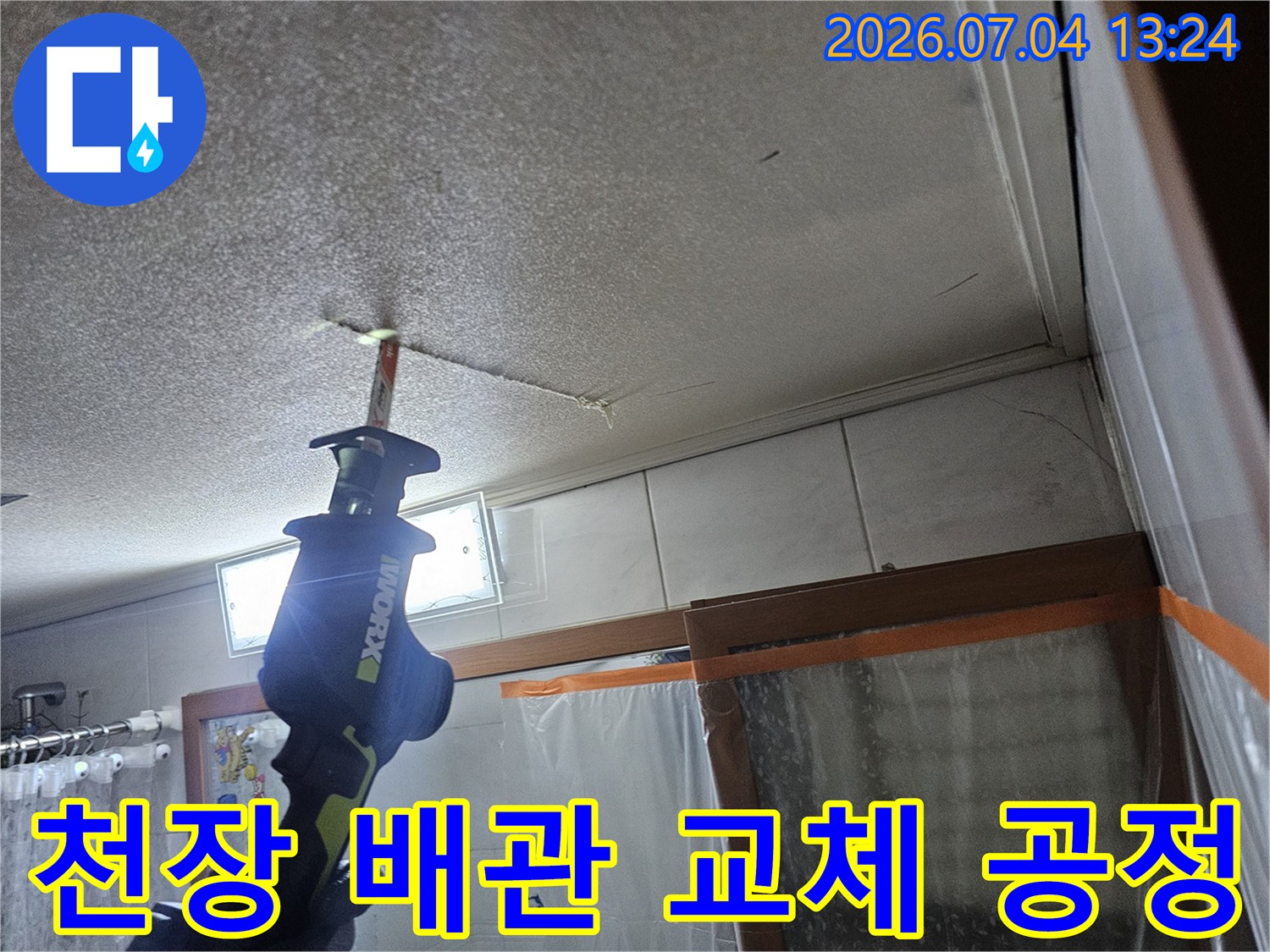 천장 점검부 내에서 노후된 수도 배관을 잘라내고 새로운 부품으로 교체하는 실제 작업 장면입니다.