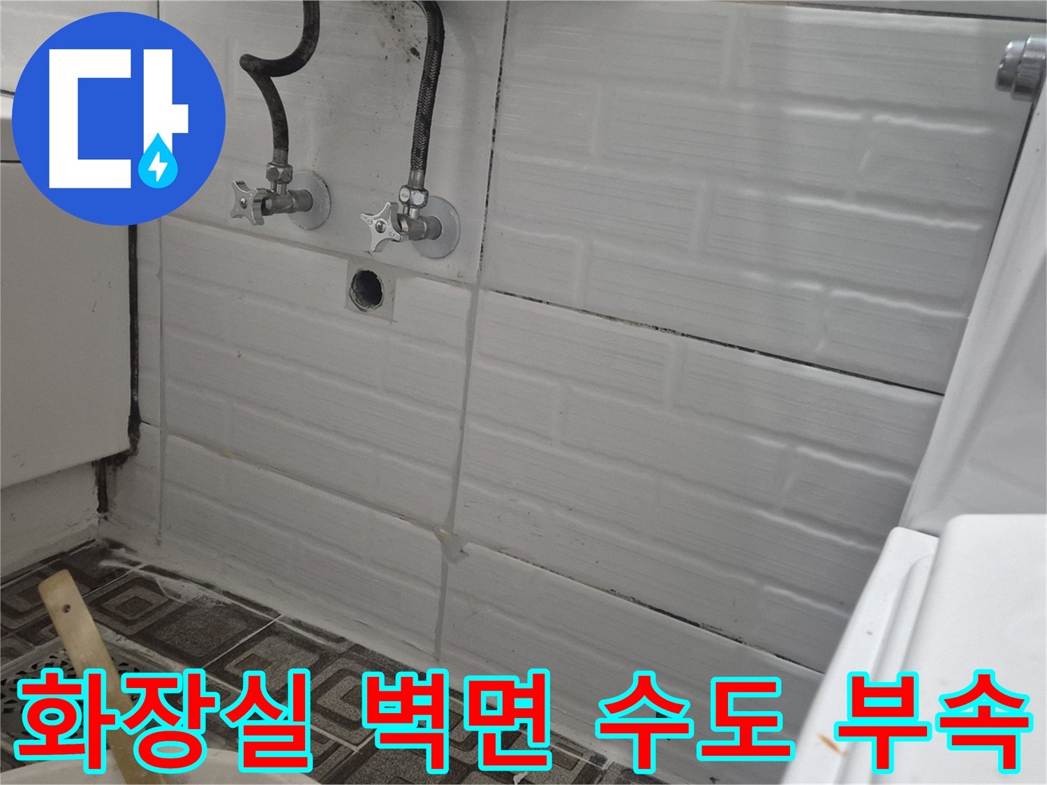 벽면에 돌출된 수도꼭지와 연결 배관의 근접 촬영