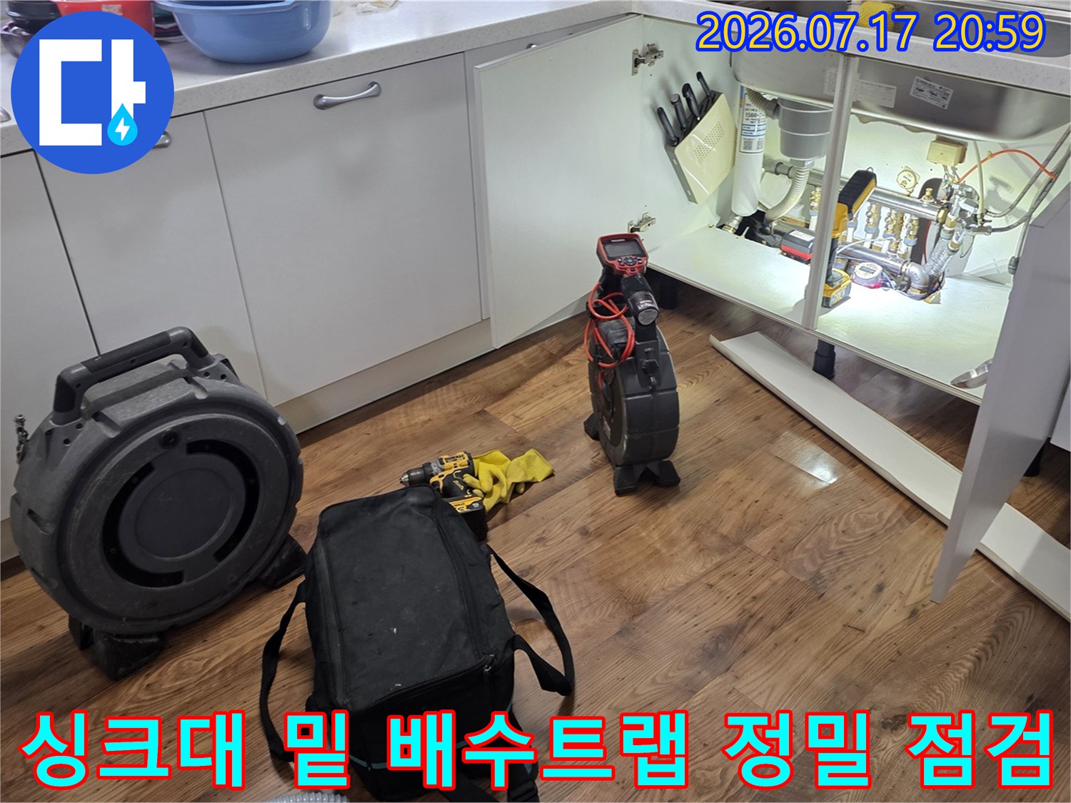 전문 장비를 설치하여 싱크대 하단 배출 트럼과 연결부의 이상 여부를 꼼꼼하게 살피는 모습