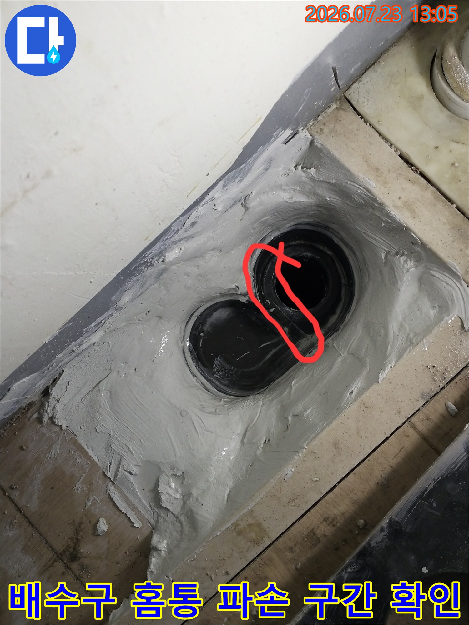 균열이 발생한 세탁실 배수관 연결 부위의 근접 촬영 이미지