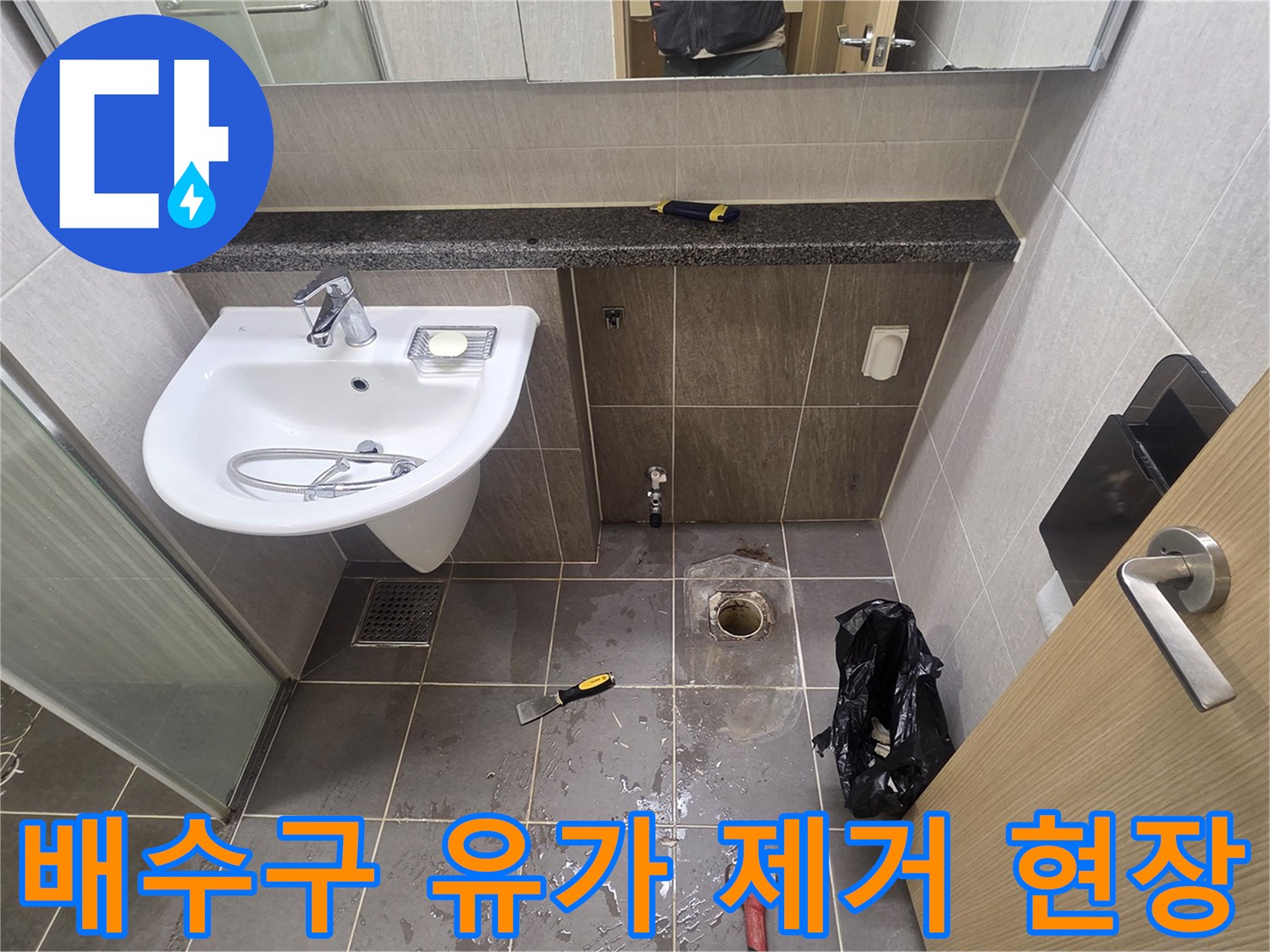 세면대 아래 배수관 주변의 타일 철거 및 점검 상태