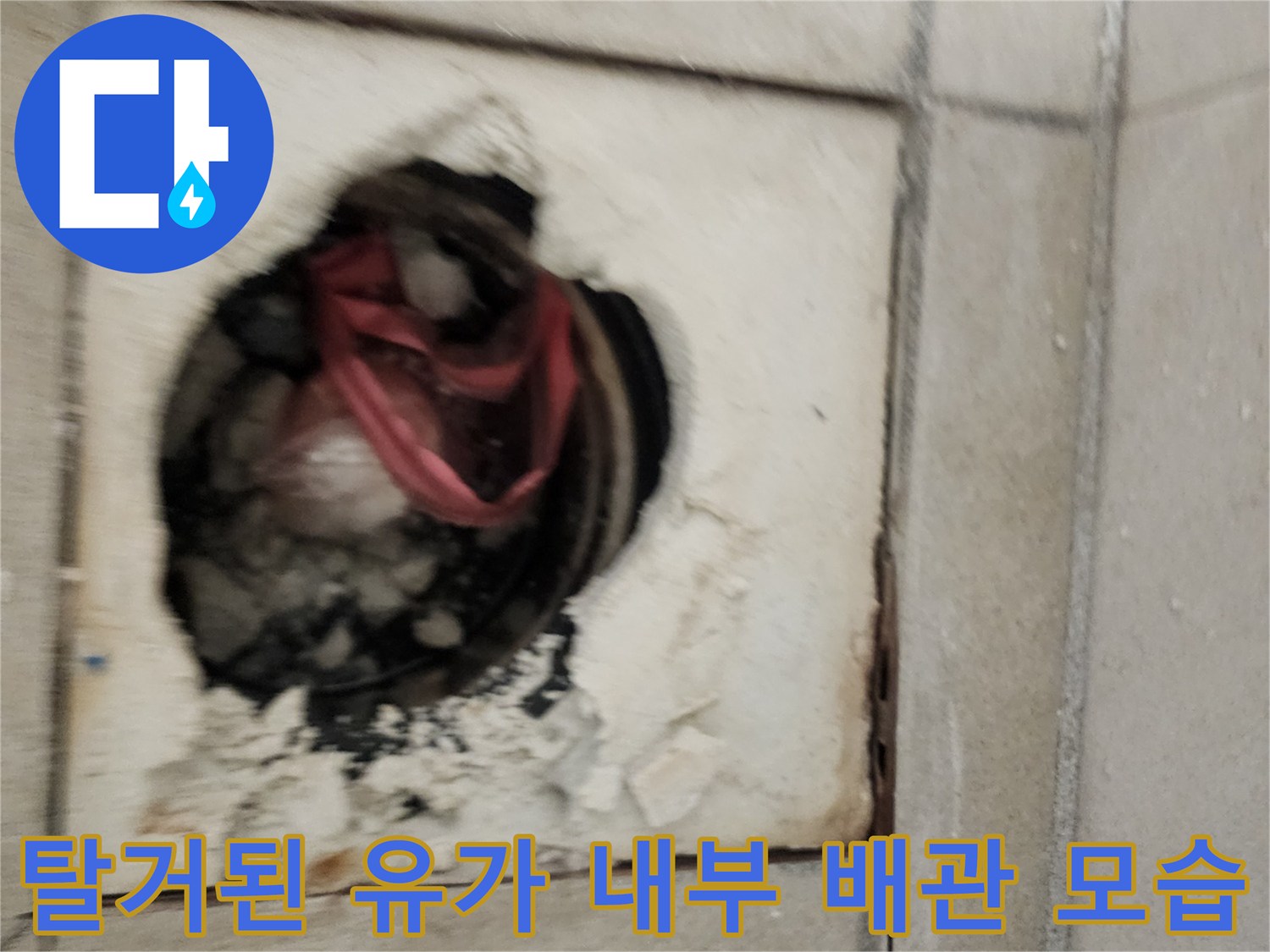 유가 탈거 부위의 노출된 하수관과 파손된 타일 마감재