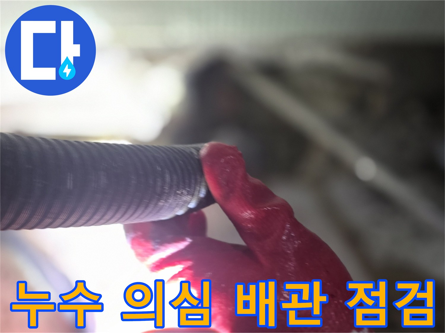 붉은 장갑을 낀 손으로 검사 중인 유연한 배관