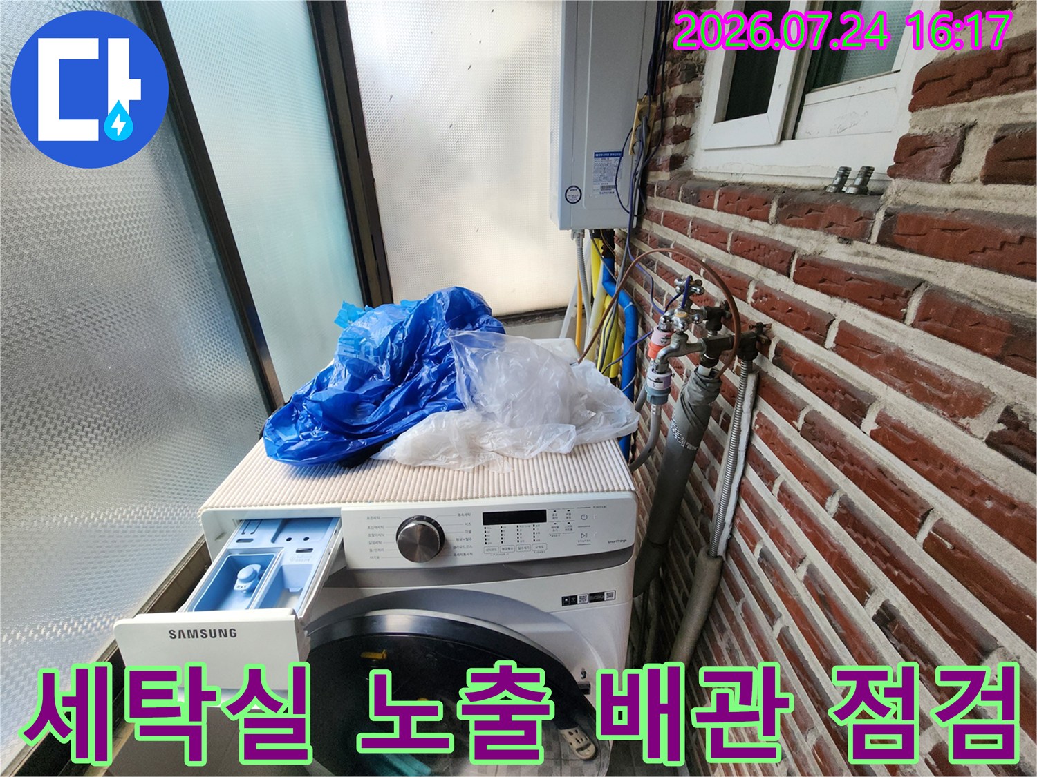 세탁기 위쪽과 벽면으로 이어진 노출형 수도 배관을 정밀하게 점검하는 모습