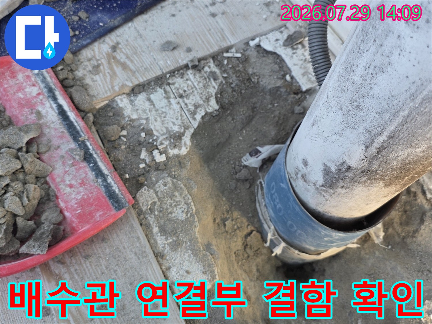 하수 배출구가 노출된 상태에서 연결 부위를 점검하는 사진