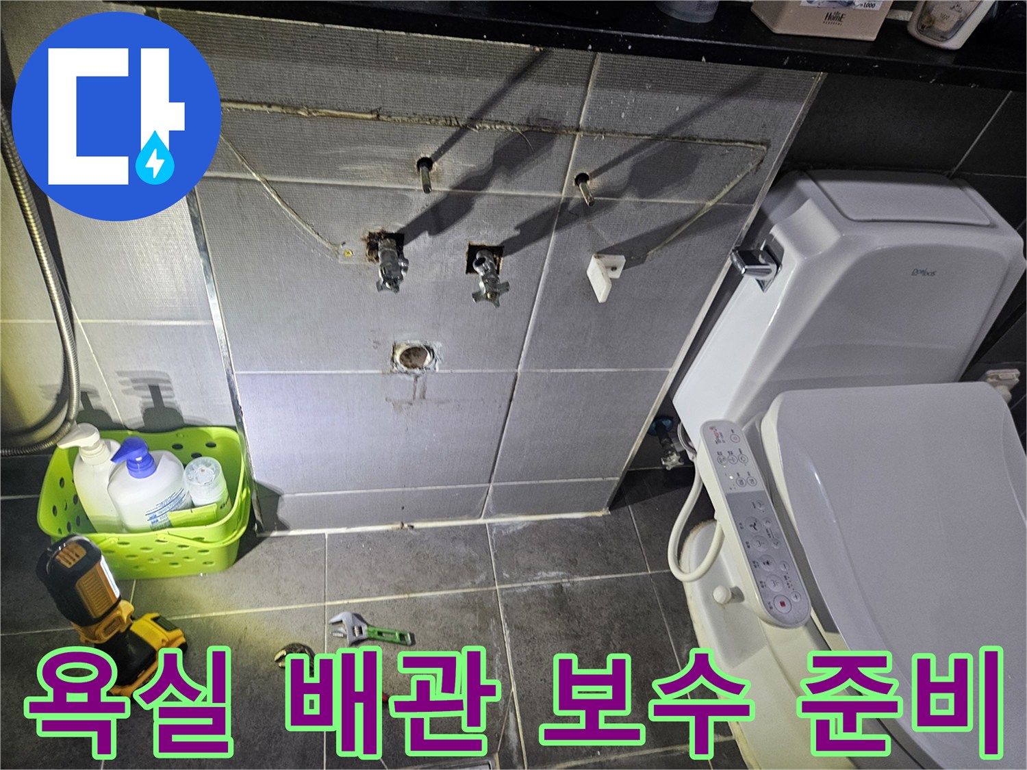 타일 작업 부위 주변에 배치된 렌치와 배관 세척 용품