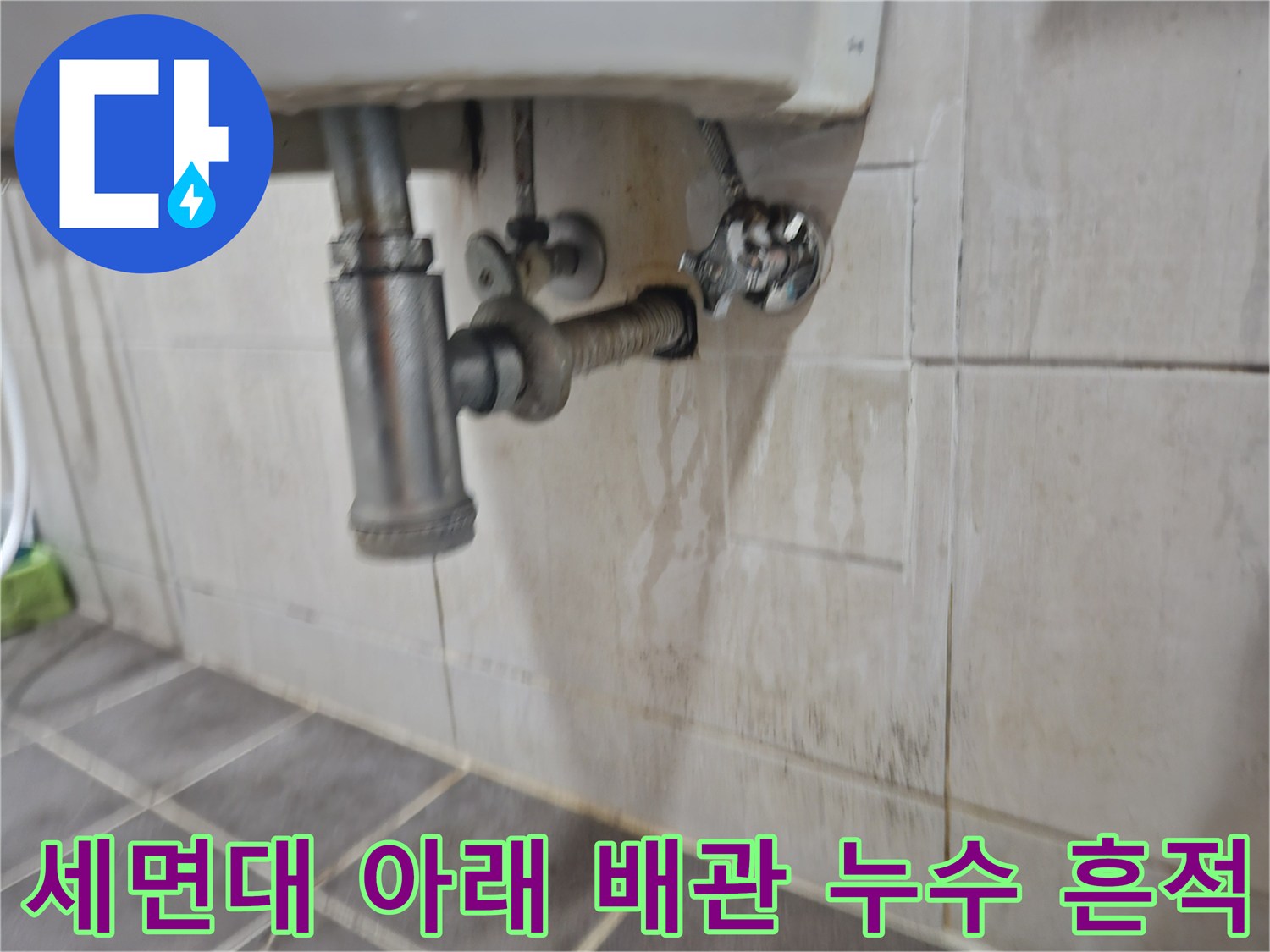 배관 연결 부위 근처 타일의 젖은 자국과 얼룩