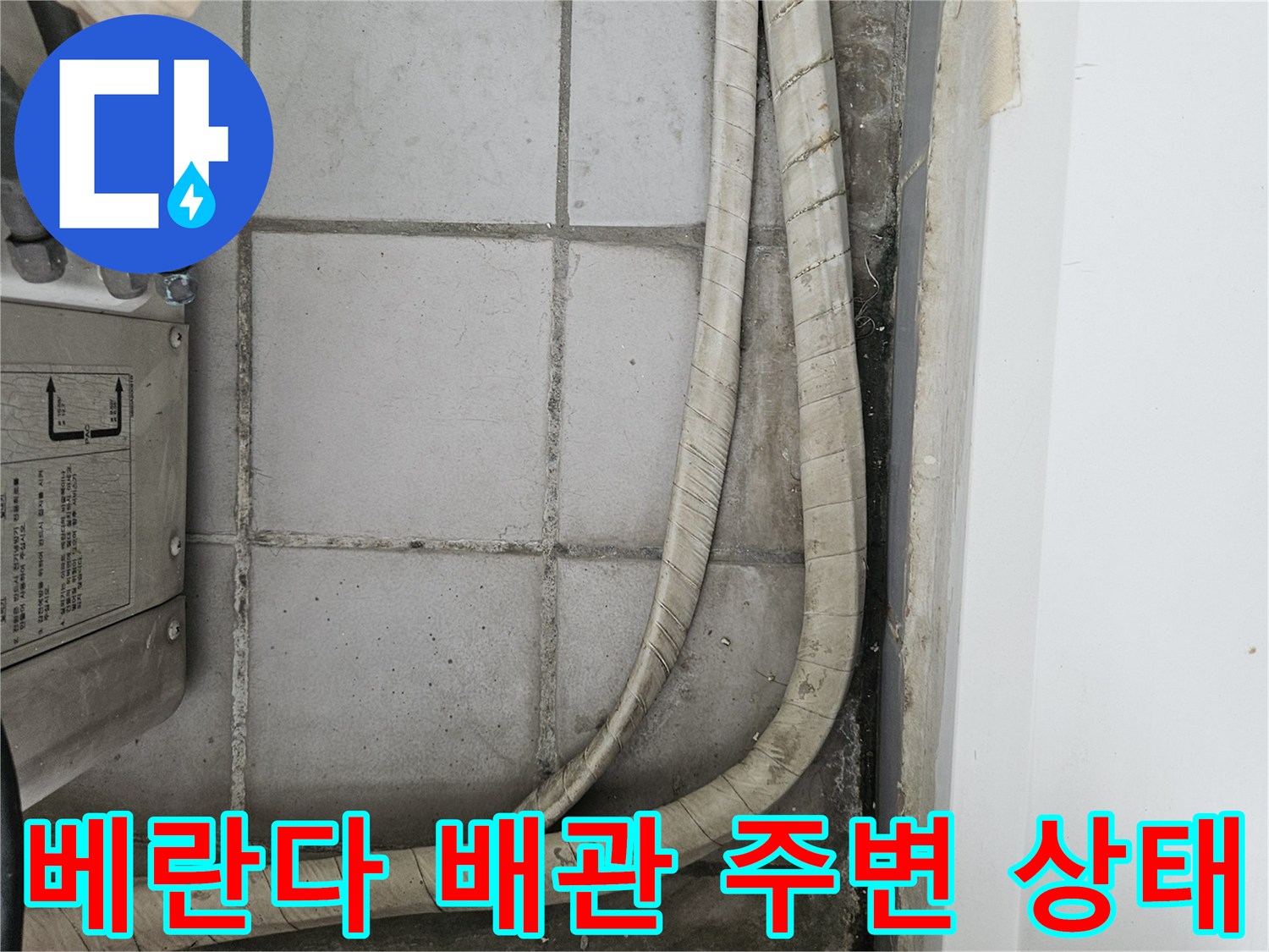 베란다 타일 벽면에 위치한 우수관 및 보온재 마감 상태입니다.