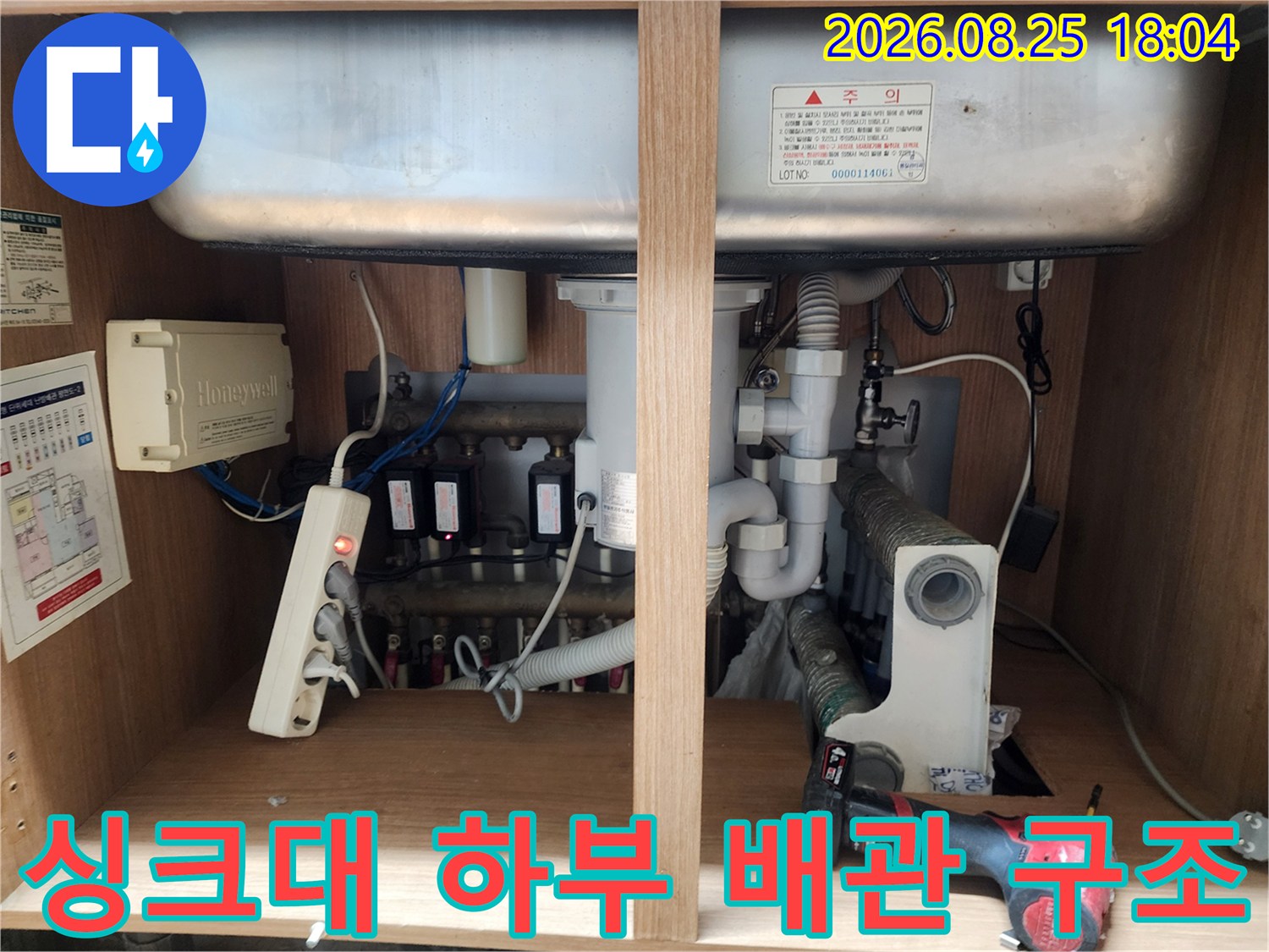 싱크대 아래 수납장 내부의 배수 트랩 및 연결 호스 점검 사진