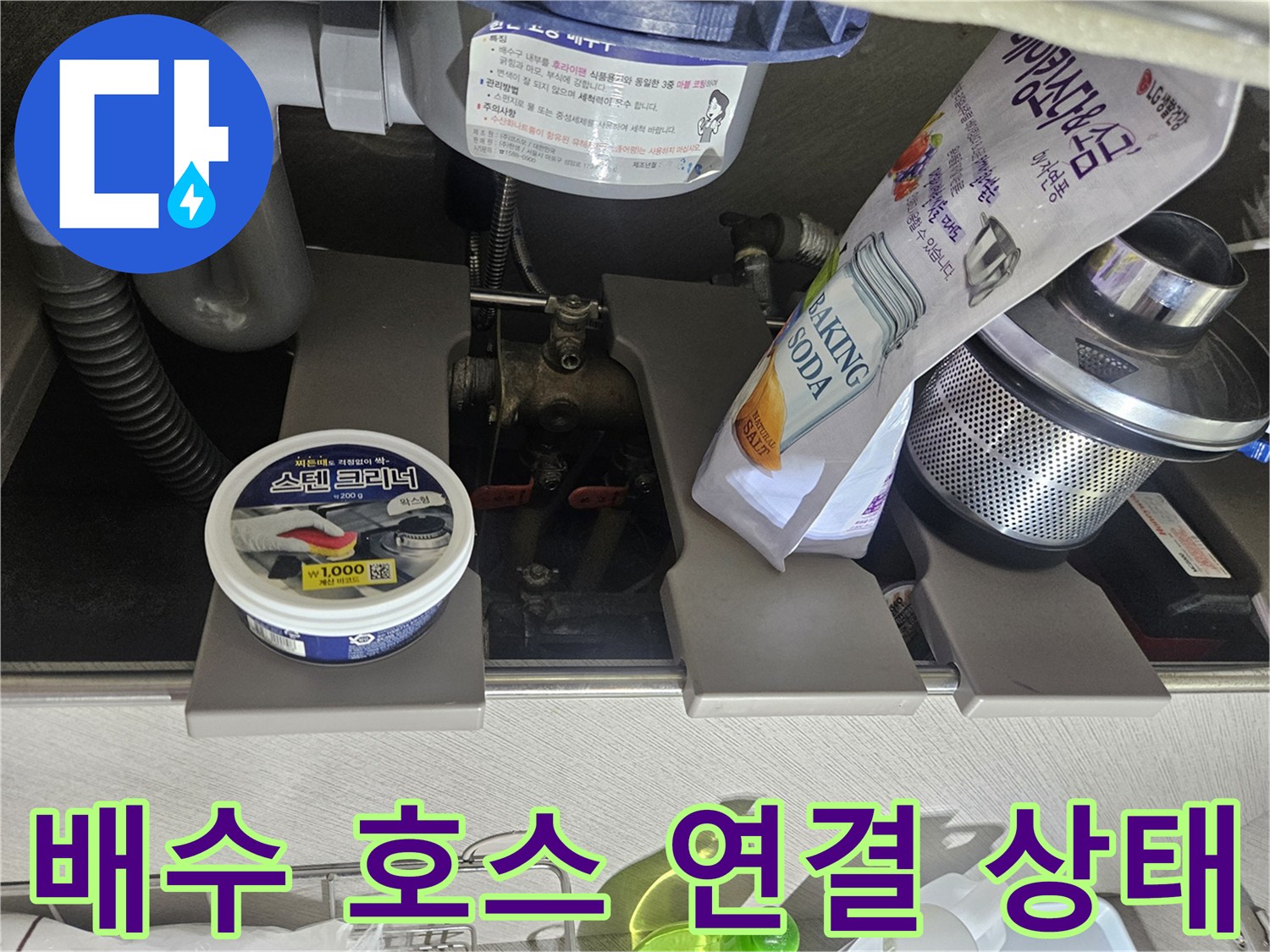 회색 굴곡진 배수 호스와 벽면 연결 배관의 모습