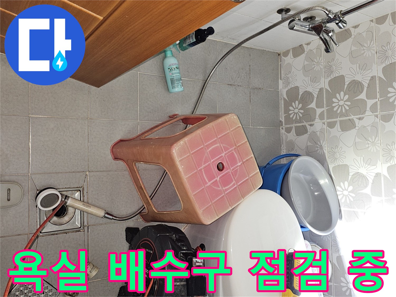 화장실 바닥 배수구 주변에 정밀 진단 장비를 배치하여 누수 지점을 찾는 모습입니다.