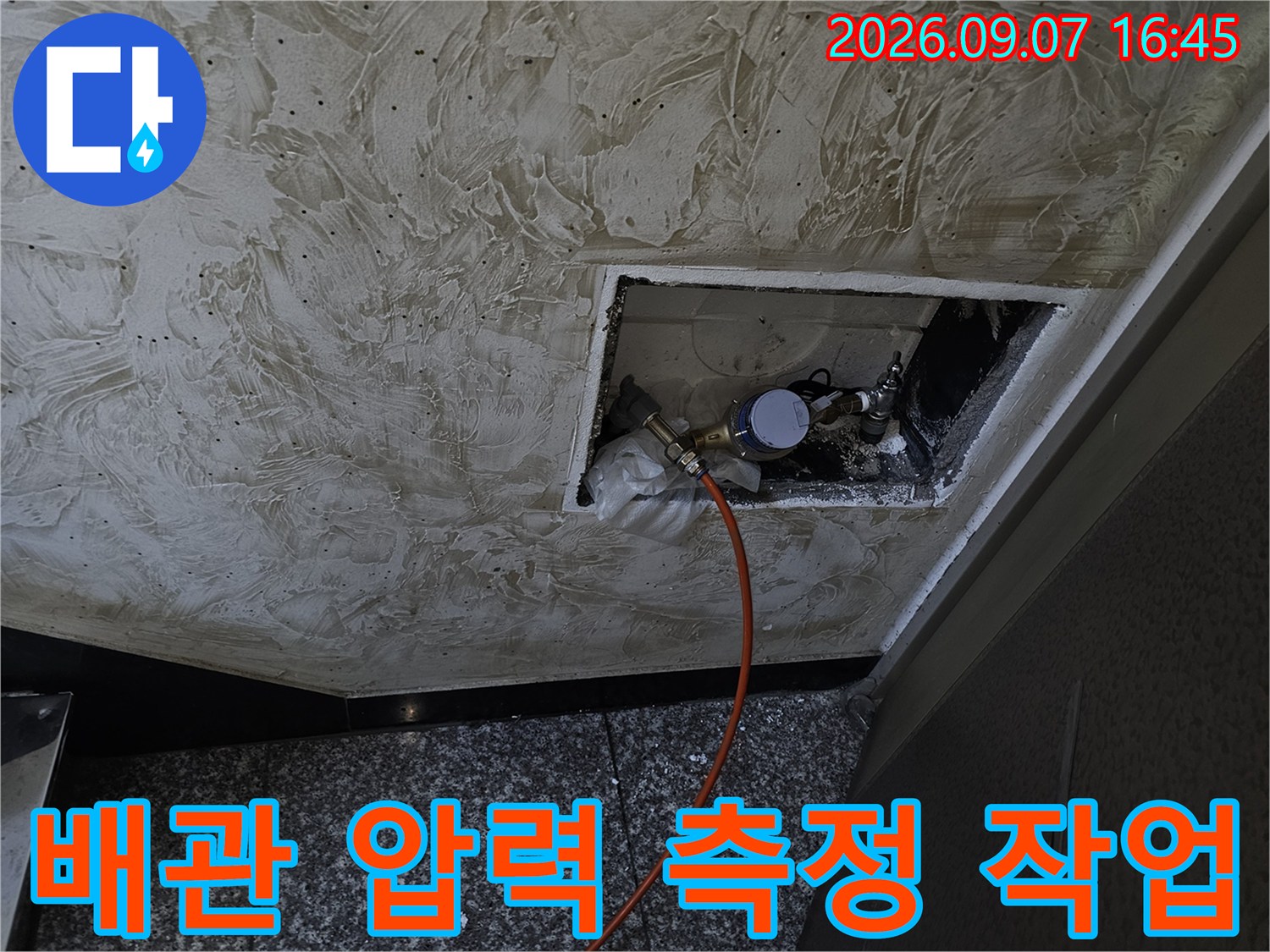 천장 점검구 내부 배관에 설치된 압력계와 연결 호스
