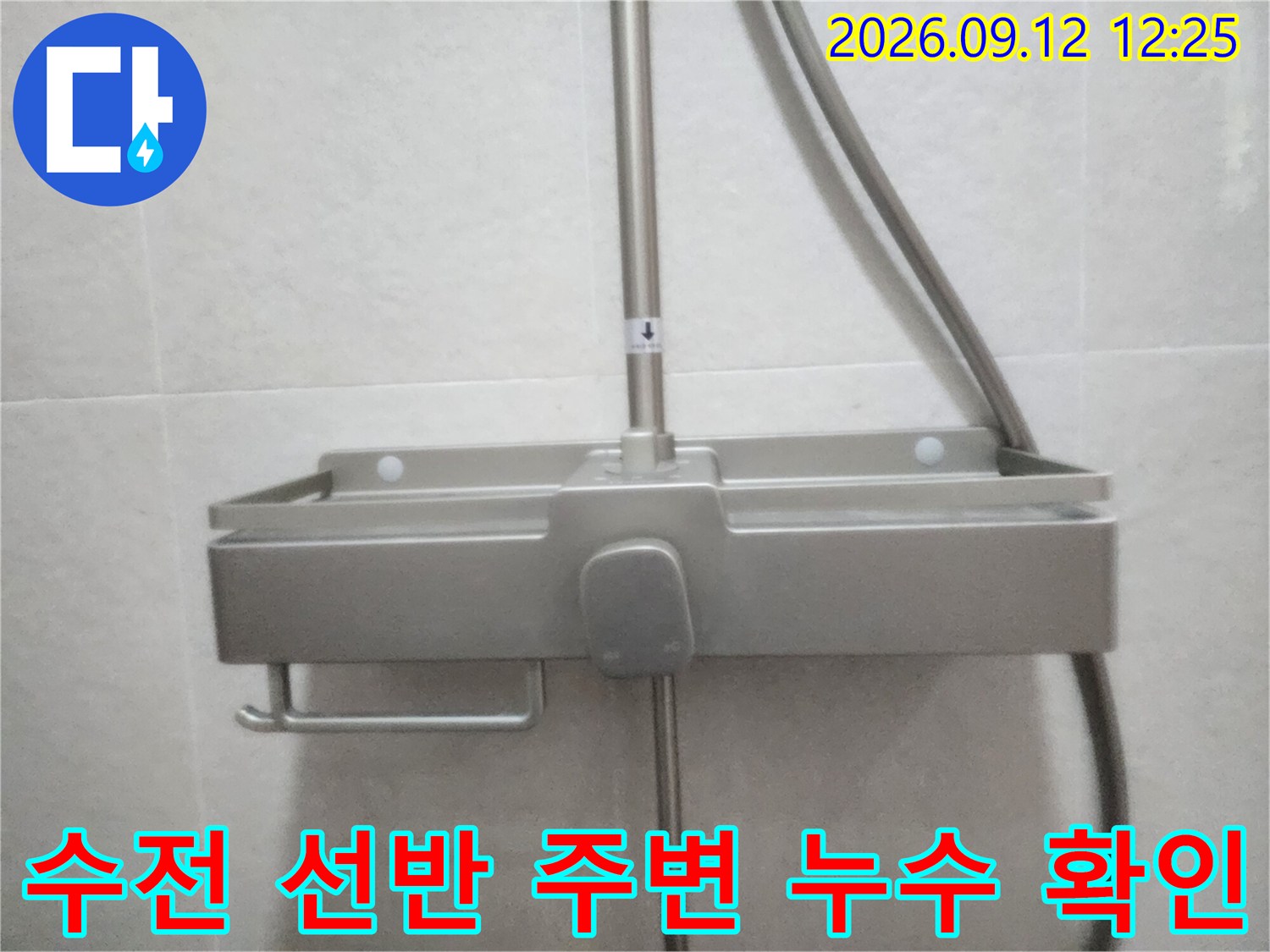금속 재질의 샤워기 선반과 수직 배관 연결 부위 상세 사진
