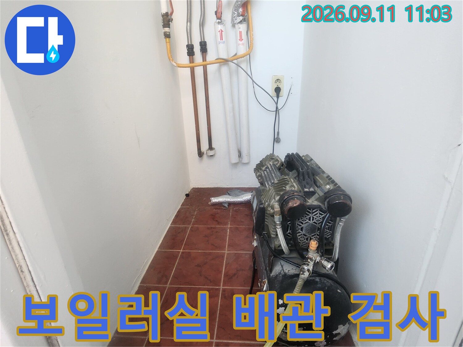 보일러 하단 배관에 연결된 공압 테스트 장비와 압력계